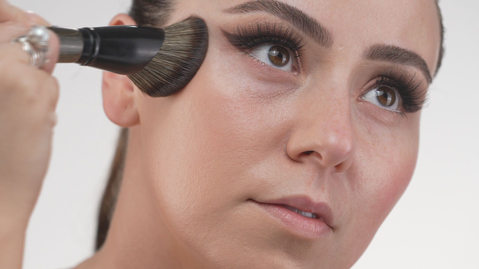 Working makeup brush into face